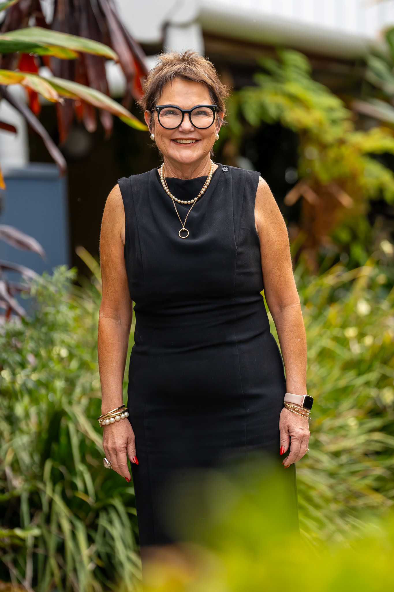 Portrait of Jane Egan, College Principal of Emmaus College, standing outdoors in a landscaped school setting