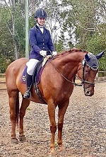 Student riding a horse in equestrian competition wearing formal riding attire