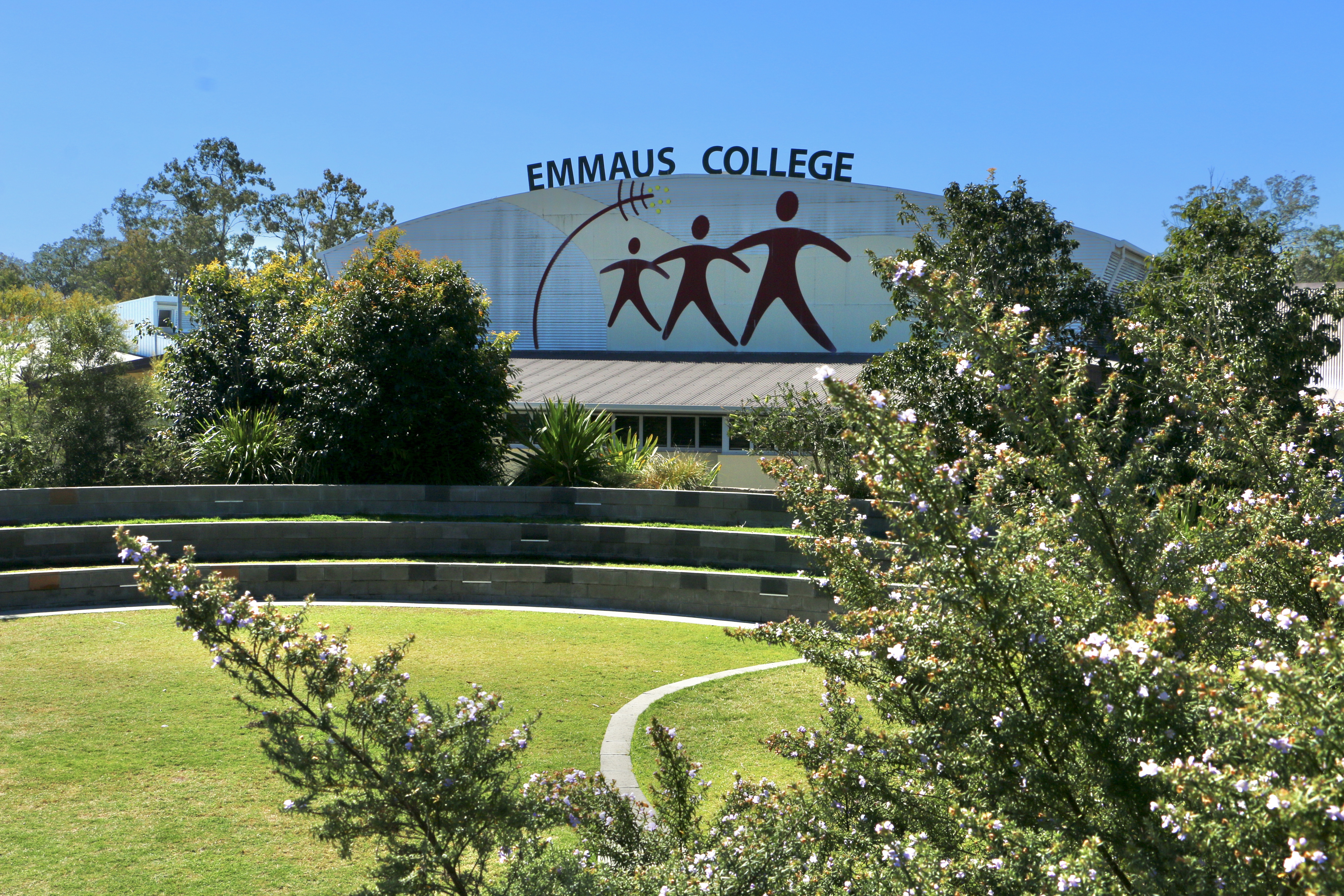 Emmaus College building with school name signage and landscaped gardens in the foreground