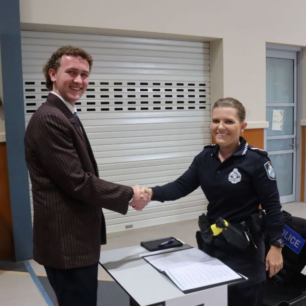 Emmaus College student shakes hand of QLD Police officer who interviewed him