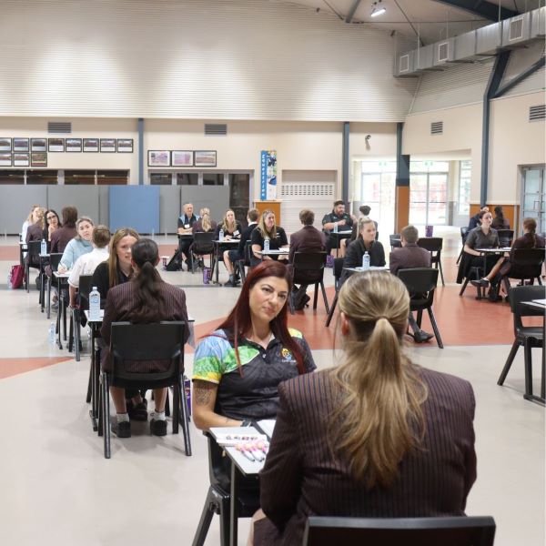 Room of local industry professionals contducting interviews with Year 10 students